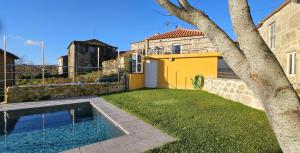 a backyard with a pool and a house at Casa Lima - AL in Valença