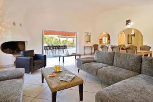 a living room with couches and a fireplace at U Paesolu in Sainte-Lucie de Porto-Vecchio