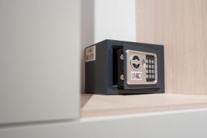 a black and gray clock sitting on a shelf at B&B viktoria city house in Castrovillari