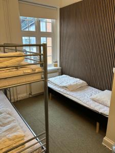 two bunk beds in a room with a window at Danhostel Odense City in Odense