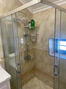 a shower with a glass door in a bathroom at Villa near SeaBreeze Nardaran Baku in Baku