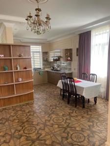 a kitchen and dining room with a table and chairs at Villa near SeaBreeze Nardaran Baku in Baku