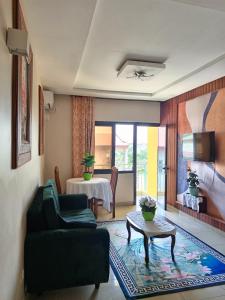 a living room with a couch and a table at RÉSIDENCE DES 7 COLLINES in Yaoundé