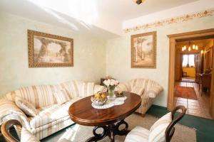 a living room with two couches and a table at Residence Moritz in Mozirje