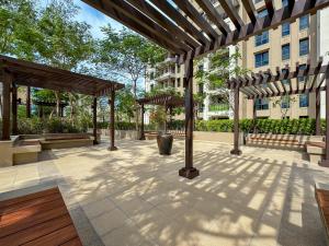 a pergola in a courtyard of a building at Trophy - Blissful Haven with Breathtaking View in Dubai
