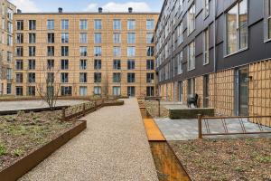 a walkway in front of a building with buildings at Little luxury apartment in Aarhus