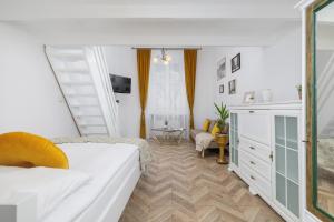 a bedroom with a bed and a table in a room at Studio Apartment with Mezzanine near Kraków City Centre by Renters in Krakow