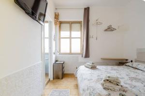 a bedroom with a bed and a television in it at B&B Arcipelago in La Maddalena