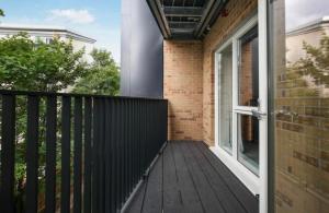 a balcony with a black fence and a door at 2 Bedroom Apartment In Kew Bridge in Kew Bridge