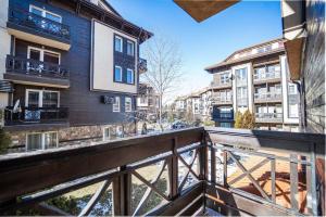 an apartment balcony with a view of buildings at 2BD App in Bojurland FREE Pool SPA Parking and Skishuttle in Bansko