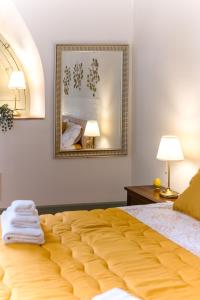 een groot geel bed in een kamer met een spiegel bij Sikelia Luxury home in Catania