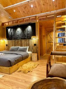 a bedroom with a bed in a wooden room at FAYUL RETREAT - India Highest Glamp and EcoLuxury Stay in Kalpa