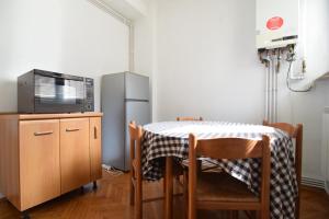 a kitchen with a table and a refrigerator at Eminescu 36 in Bucharest