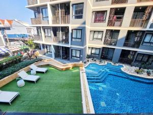 an apartment building with a swimming pool next to a building at The Urban Condo in Central Pattaya in Pattaya Central