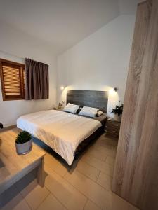 a bedroom with a large bed in a room at BuzzStays: 1-Bed Bungalow, Garden, Near Yumbo & Beach in Maspalomas