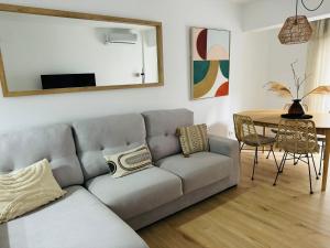 sala de estar con sofá y mesa en El Encanto de la Playa Santa Mª Grupo AC Gestion en Cádiz