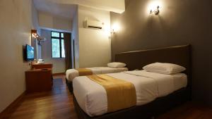Postel nebo postele na pokoji v ubytování Zen Zeng Hotel