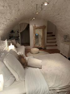 a bedroom with two white beds and a mirror at CHARME RAMATUELLE in Ramatuelle