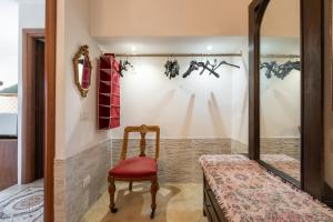 a room with a chair and a mirror at Lovely house in Santa Luria