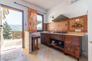 a kitchen with a counter and a large window at Lovely house in Santa Luria