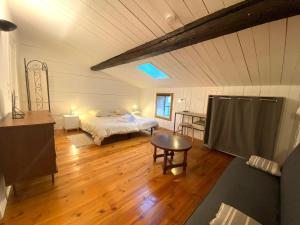 ein Schlafzimmer mit einem Bett und einem Tisch in einem Zimmer in der Unterkunft Le Clain de Vivonne, cosy appartement plein centre in Vivonne