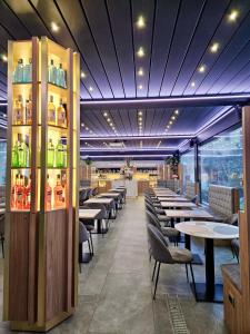 a dining room with tables and chairs and lights at Hotel Bolzano in Milan