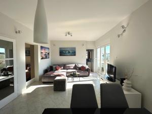 a living room with a couch and a tv at Spacious 3BDR App in Center "Sunny Bayside" in Zadar