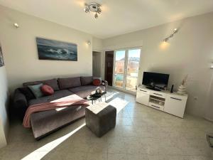 a living room with a couch and a television at Spacious 3BDR App in Center "Sunny Bayside" in Zadar