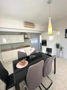 a living room with a dining table and chairs at Spacious 3BDR App in Center "Sunny Bayside" in Zadar