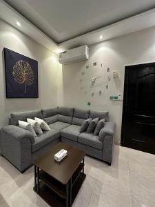 sala de estar con sofá y mesa en هابي رومز en Al Khobar