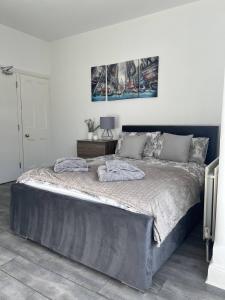a bedroom with a large bed with two pillows on it at Abington Park 5 Bedrooms with en-suite in Spinney Hill