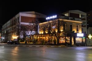 a building on a city street at night at Hotel Ma Belle in Pristina