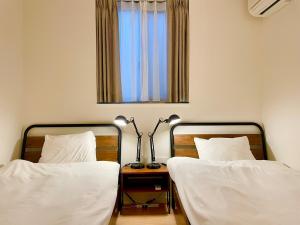 Postel nebo postele na pokoji v ubytování SALON Shibuya