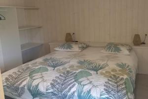ein Bett mit zwei Kissen auf einem Zimmer in der Unterkunft Une pause Champêtre : gîte avec terrasse in Saint-Cierge-sous-le-Cheylard