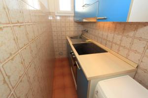 a small bathroom with a sink and a toilet at Alfa Apartmerts in Lido di Pomposa