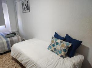 a bedroom with a bed with a pillow on it at Alojamiento El palmeral in Santa Pola +16 photos