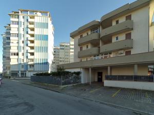 an empty street in front of a building at Alfa Apartmerts in Lido di Pomposa
