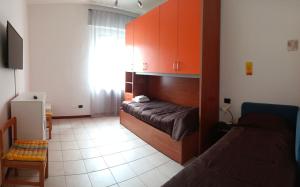 a bedroom with a bed and a couch in a room at Pitagora in Pavia