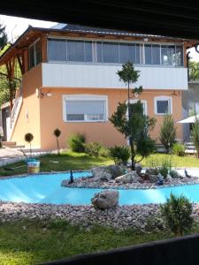 a house with a swimming pool in front of a house at Pedjin Kutak Brcko in Vražići