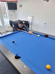 a man playing a game of snooker on a pool table at Pedjin Kutak Brcko in Vražići
