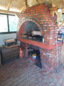 a brick oven with a chicken cooking in it at Pedjin Kutak Brcko in Vražići