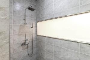 a shower with a glass door in a bathroom at Incheon Aiport Airrelax hotel in Incheon