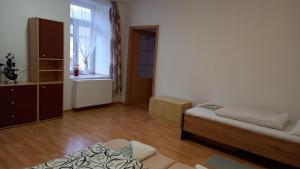 a living room with two beds and a window at Apartmán v Ladově kraji in Ondřejov