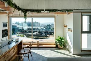 an office with a desk and a large window at Norden Ruder Hostel Taichung in Taichung