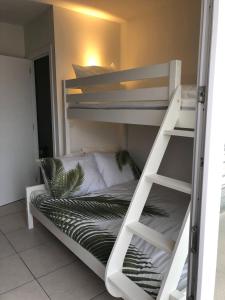 białe łóżko piętrowe w pokoju z łóżkiem piętrowym w obiekcie Volledig gerenoveerd 2 slaapkamer appartement, 250 m van het strand w mieście Middelkerke