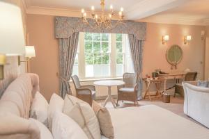 a bedroom with a bed and a table and a window at Owston Hall Hotel in Doncaster