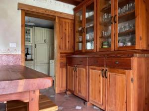 a kitchen with wooden cabinets and a table at Traditional Slovenian house in Vransko