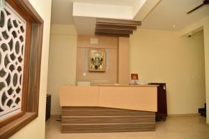 a lobby with a reception desk in a building at ARIVU LODGE AC in Coimbatore