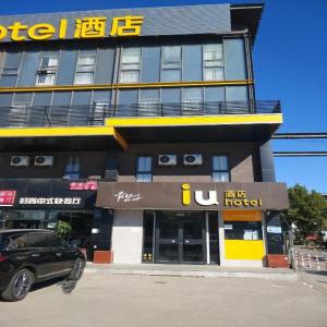 a building with a car parked in front of it at IU Hotels Beijing Changping Bei Qijia in Changping