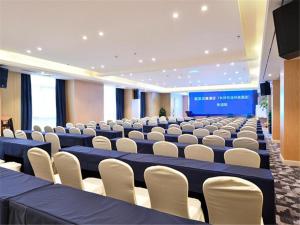 a large room with rows of chairs and a stage at Kyriad Hotel Changsha Environmental Protection Science and Technology Park in Yangtianhu